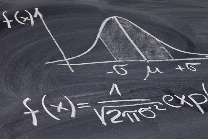 Gaussian or bell curve on a blackboard